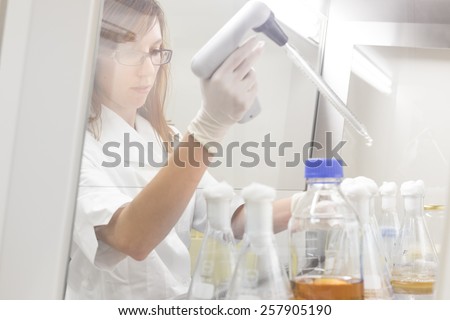 Life scientist researching in laboratory. Life sciences study living organisms on the level of microorganisms, viruses, human, animal and plant cells, genes, DNA...