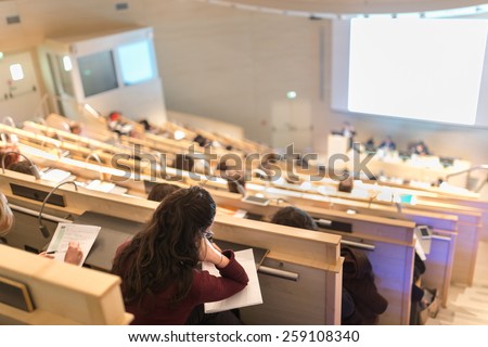 Conference and Presentation. Audience at the conference hall. Business and Entrepreneurship. Faculty lecture and workshop. Audience at the lecture hall. Academic education. Student making notes.