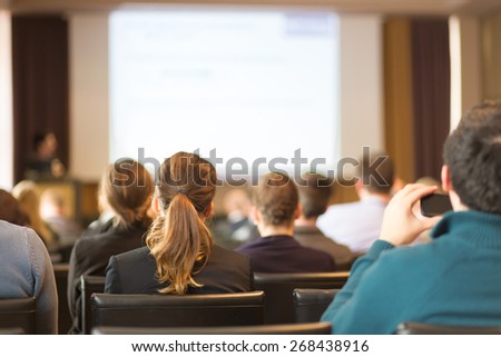 Speaker at Business Conference and Presentation. Audience in the conference hall. Business and Entrepreneurship. Copy space on white screen.