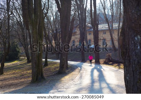 Lady running in the forest.  Running woman. Female runner jogging during outdoor workout in a Nature. Fitness model outdoors. Weight Loss. Healthy lifestyle.