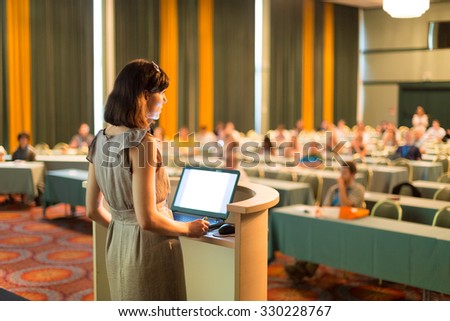 Female speaker at Business Conference and Presentation. Audience at the conference hall. Business and Entrepreneurship. Business woman. Horizontal composition.