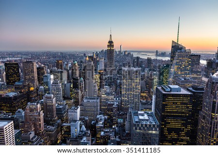 New York City. Manhattan downtown skyline with illuminated Empire State Building and skyscrapers at dusk.