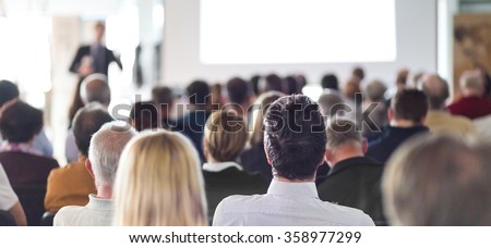 Speaker Giving a Talk at Business Meeting. Audience in the conference hall. Business and Entrepreneurship. Panoramic composition suitable for banners.