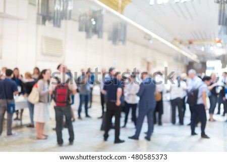 Abstract blurred people socializing during coffee break at business meeting or conference.