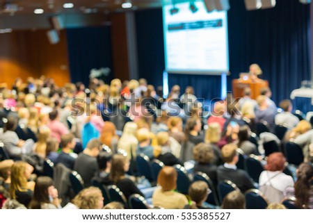 Blured image of audience in conference hall attending business conference. Business and Entrepreneurship concept.