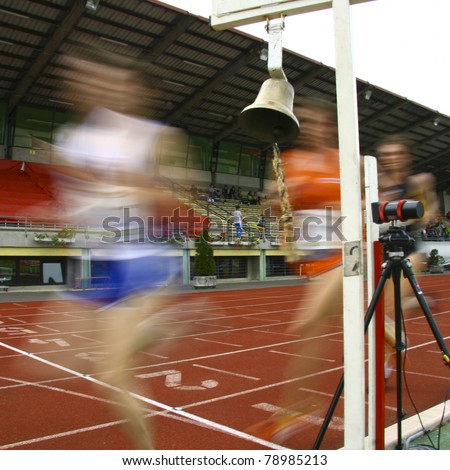 A motion blur of the runners crossing the finish line.