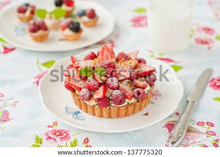 tart with pistachio nuts cream and berries