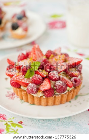 tart with pistachio nuts cream and berries
