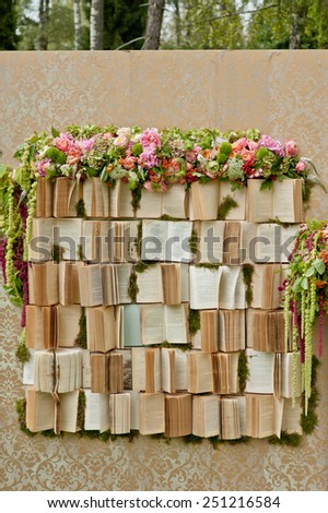 wedding photo-booth decoration zone decorated with a lot of books