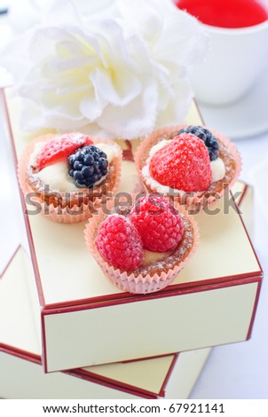 delicious fresh berry cakes and a cup of red tea