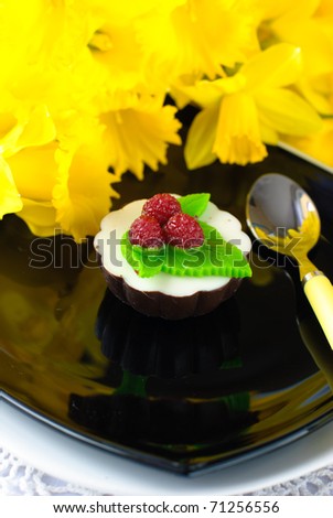cake from jelly with raspberries and daffodil flowers