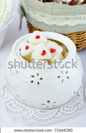 Sugar in shape of heart in white sugar bowl