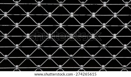 diamond shaped metal grid on black background