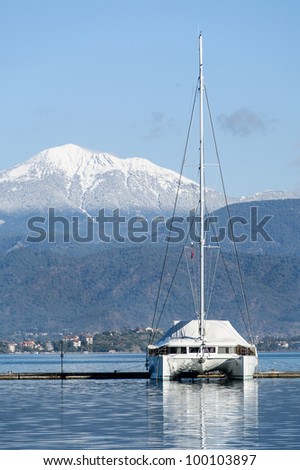 Sailing catamaran morred. Vetrical image with mountain background