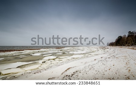 Baltic sea shore in ice and snow in the beginning of winter