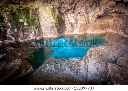 Sparkling turquoise blue water of the Grotto at Bruce Peninsula National Park, Tobermory Ontario, Canada