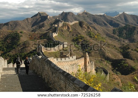 A couple takes a stroll along the winding spine of the Great Wall of China