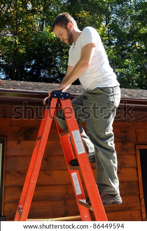 Man climbing ladder to roof for repairs