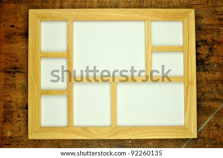 Empty wooden picture frame, on rustic wooden background