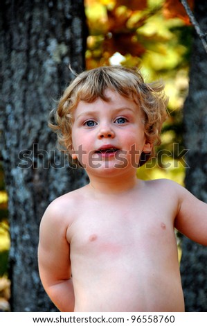 Young boy plays outside in autumn