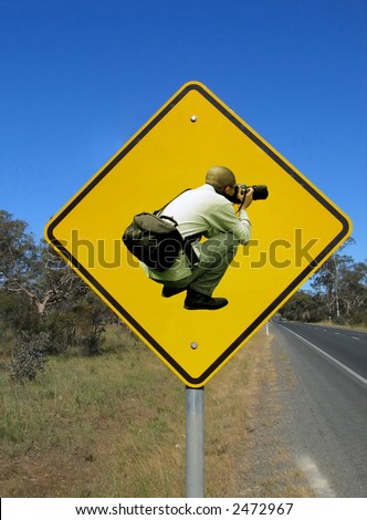 ... Caution photographers ahead. Funny road sign against the blue sky