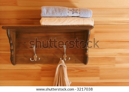 Guest house interior. Shelf and towels.