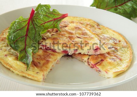 Omelette with a red chard on plate