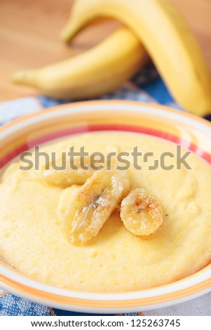 Milk porridge of maize grain with fried bananas
