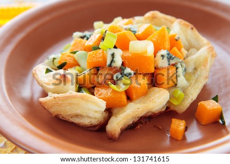 Pumpkin with blue cheese, leek and onion in puff pastry