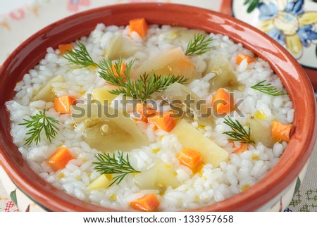 Rice soup with pickled green tomatoes, carrots and dill