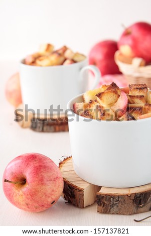 White bread pudding with apples and cinnamon in cups