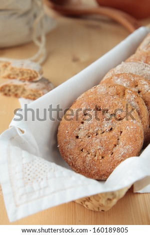 Rye bread in a rectangular basket, flour in the bag, pots