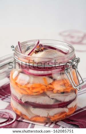 Jar of pickled herring, red onion and carrots