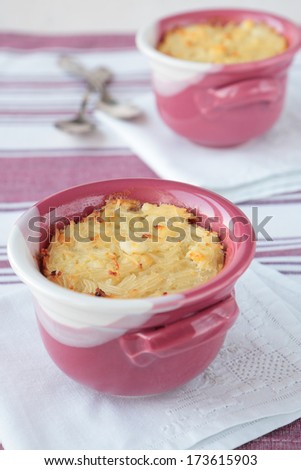 Baked pudding of noodles with cottage cheese in  bowl