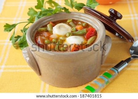 Soup with meat dumplings, green beans, peas, tomatoes, peppers