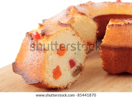 A piece of cake with candied fruits and powdered sugar