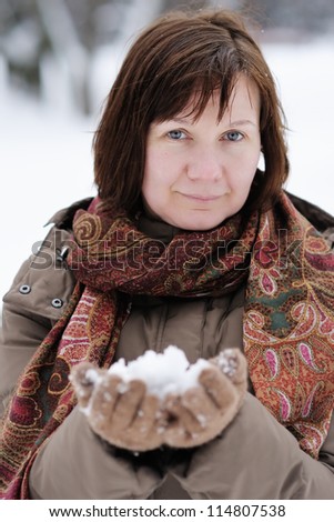 Happy middle age woman having fun in winter