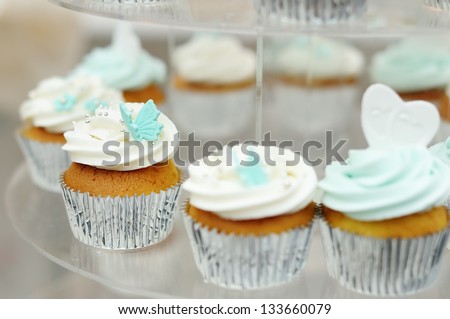 Delicious colorful wedding cupcakes with butterfly