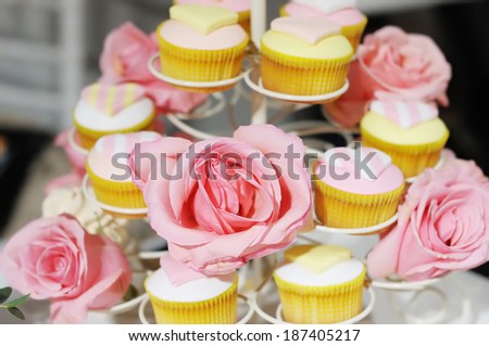 Delicious colorful wedding cupcakes, focus on flower