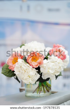 White and red flowers bouquet in glass vase