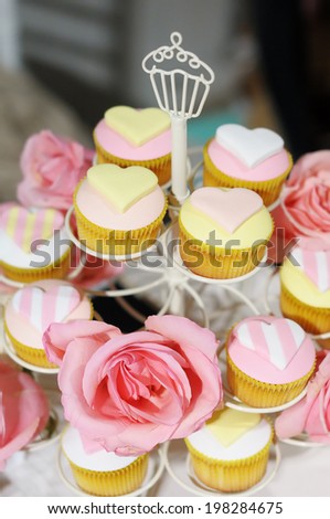 Delicious colorful wedding cupcakes on cake stand