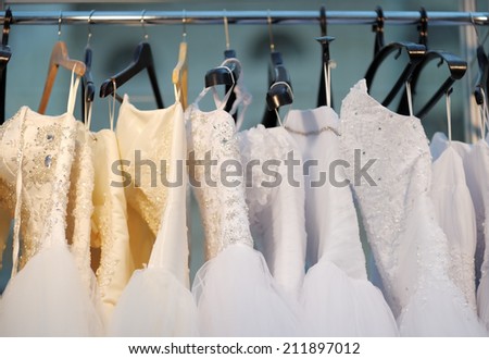 A few beautiful wedding dresses on a hanger