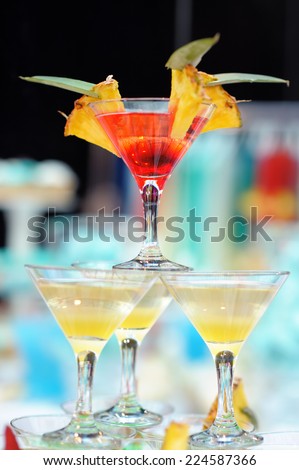 Delicious red and yellow cocktail tower with fresh pineapple (cocktail party)
