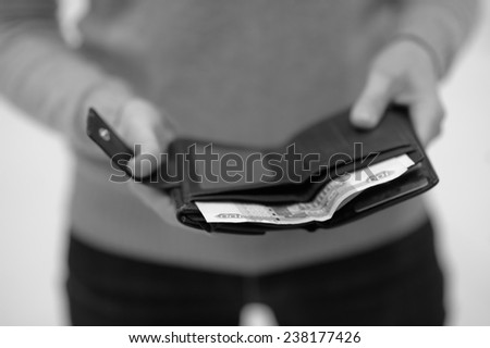 Woman holding purse with russian paper money (rubles)