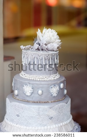 Delicious gray wedding cake decorated with flower