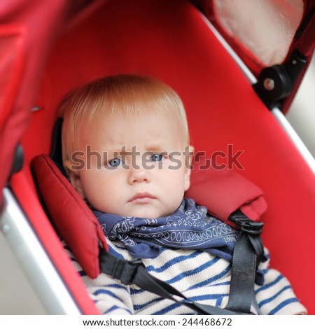 Little baby boy in stroller at the spring day