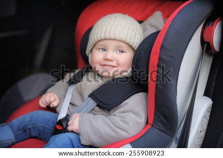 Toddler boy sitting in car seat
