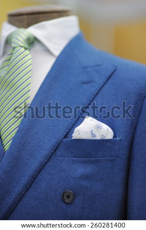 Blue suit with tie, tie clip and handkerchief. Focused on handkerchief.