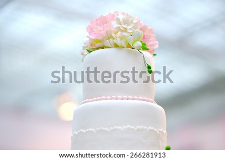 White wedding cake decorated with cream flowers