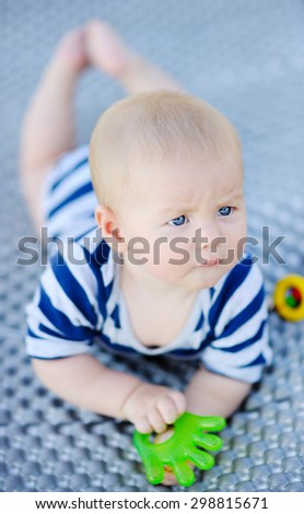 Six month old baby play with bright toy